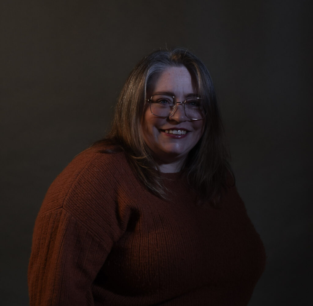 Pam posing for a birthday portrait with gentle make up and calm lighting